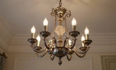 A chandelier with bronze metalwork and rock crystal pendants
