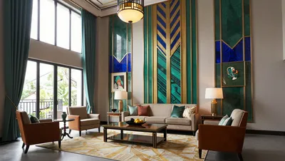 A luxurious Art Deco living room with high ceilings, large windows, and elegant furniture.