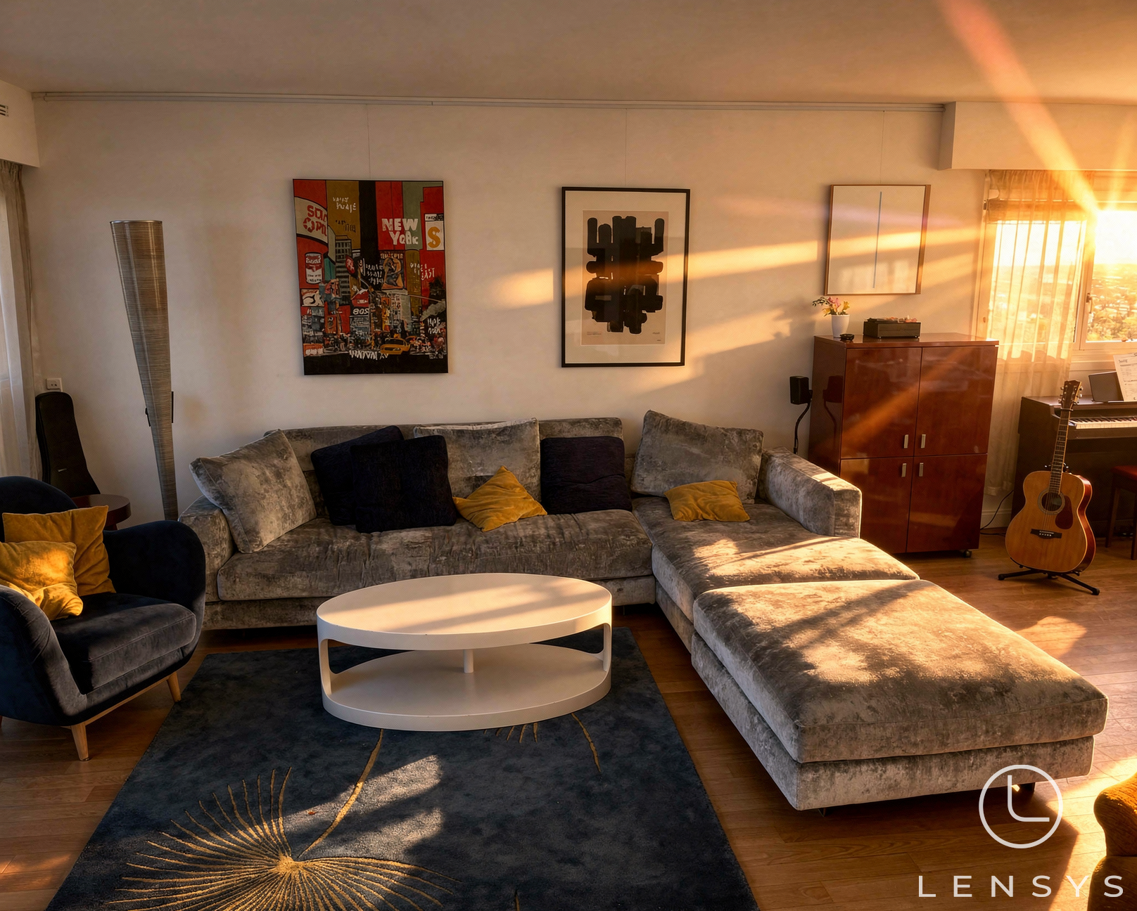 A living room with a gray sofa, a coffee table, and a rug, illuminated by warm sunlight.